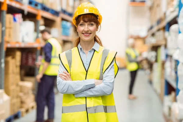 Warehouse manager smiling at camera with arms crossed — Stock Photo, Image