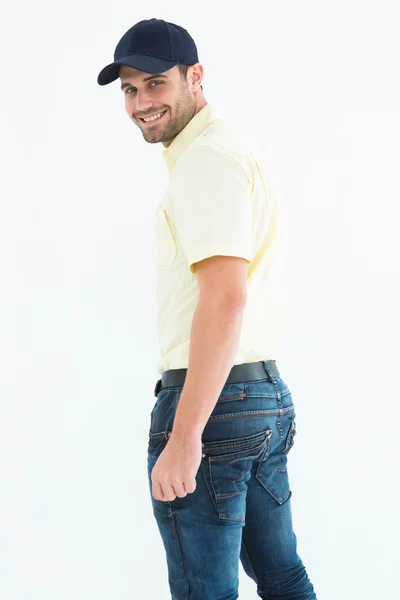 Happy delivery man wearing baseball cap — Stock Photo, Image