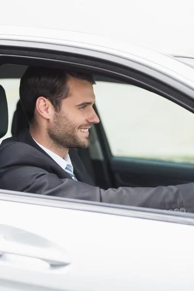 Happy businessman in the drivers seat — Stock Photo, Image
