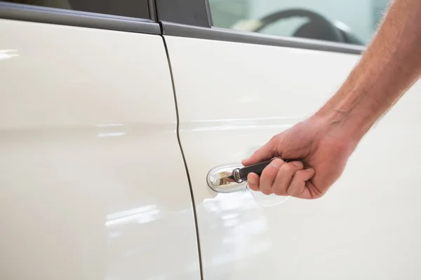 Un homme ouvre une voiture avec une clé — Photo