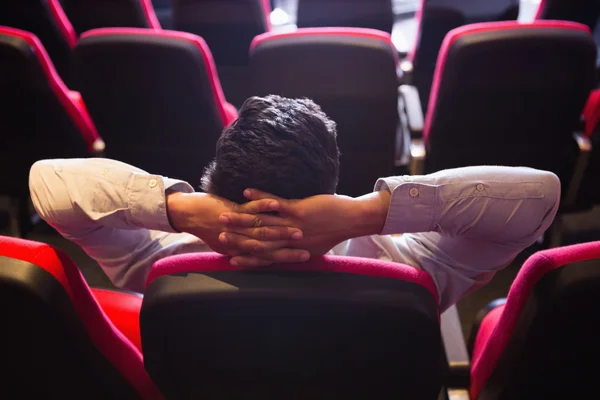 Jeune homme avec les mains tête regardant un film — Photo