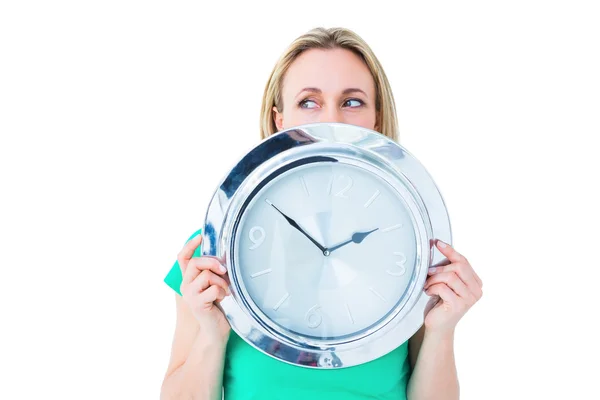 Blonde in casual clothes showing clock — Stock Photo, Image