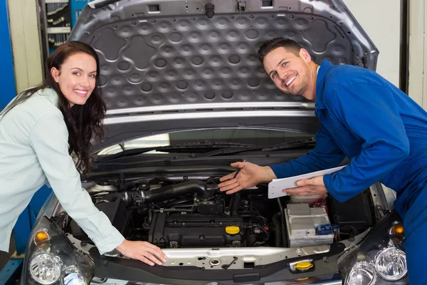 Mechanic smiling with customer — Stock Photo, Image