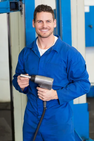 Smiling mechanic holding power drill — Stock Photo, Image