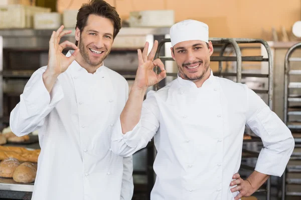 Smiling bakers looking at camera — Stock Photo, Image
