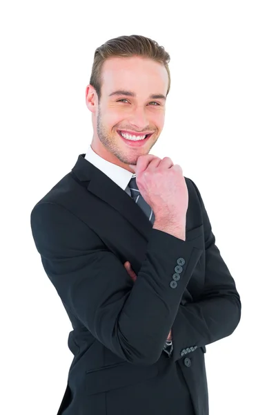 Feliz hombre de negocios de pie con la mano en la barbilla — Foto de Stock