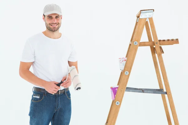 Man håller paint roller av stege — Stockfoto