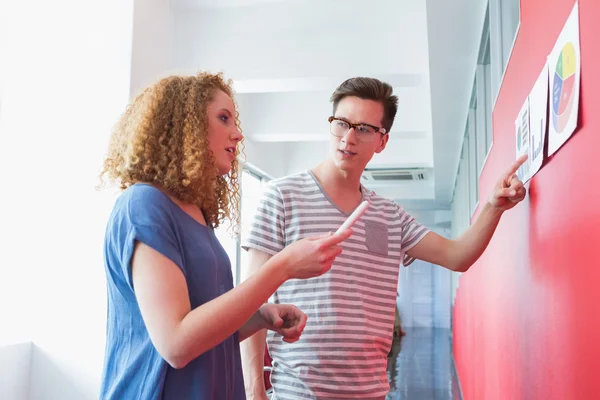Students working together with graphics — Stock Photo, Image