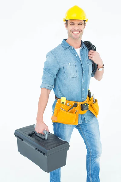 Happy electrician with tool box and wire — Stock Photo, Image