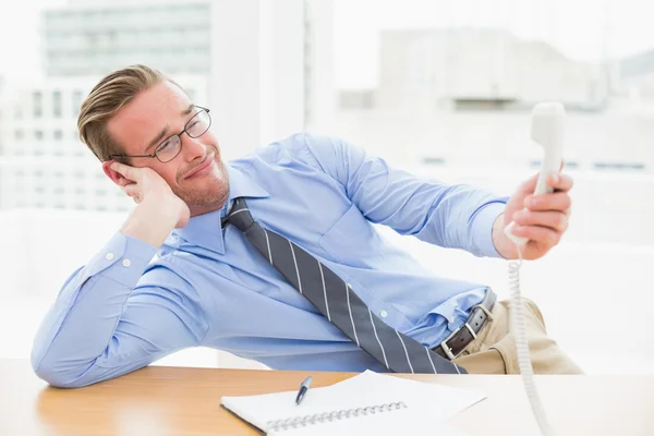 Confused businessman holding the phone — Stock Photo, Image