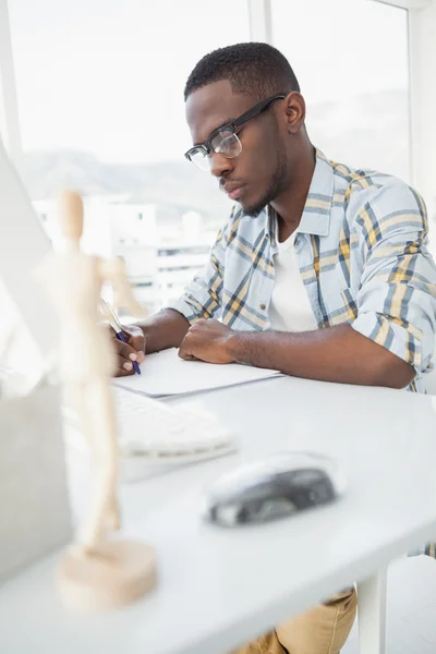 Serious businessman writing on paper — Stock Photo, Image