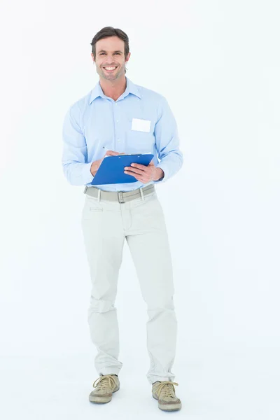 Confident businessman holding clipboard — Stock Photo, Image