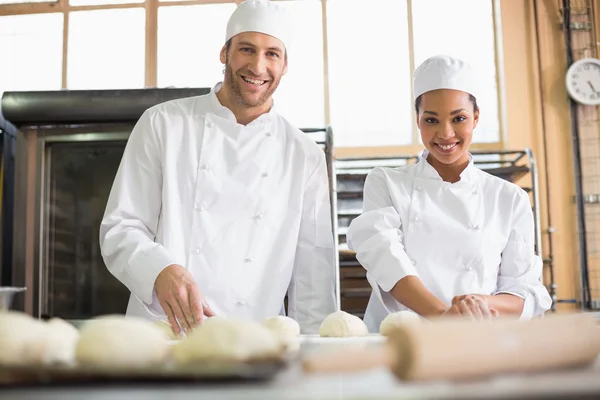 Team of bakers preparing dough — Stock Photo, Image