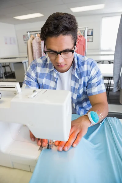 Concentrated university student sewing — Stock Photo, Image
