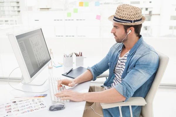 Businessman listening music and using computer — Stock Photo, Image