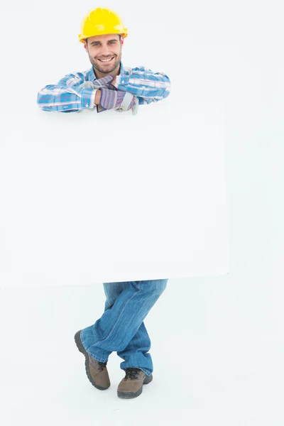 Male technicial holding blank billboard — Stock Photo, Image