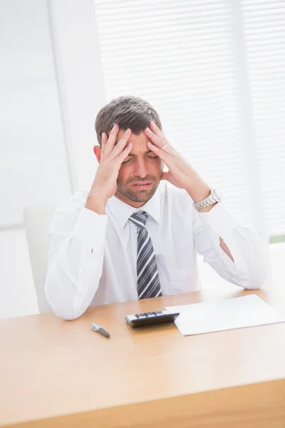 Stressed businessman with head in hands Stock Photo