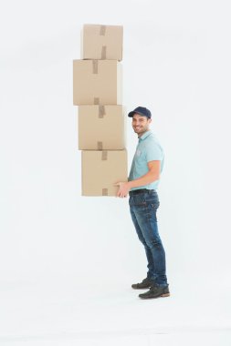 Delivery man carrying stack of boxes clipart