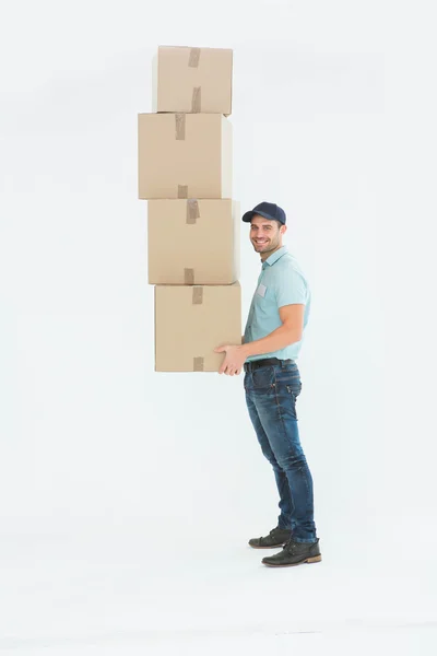 Delivery man carrying stack of boxes — Stock Photo, Image