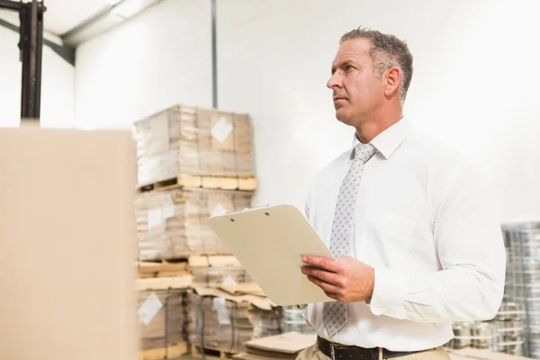 Warehouse manager checking his list — Stock Photo, Image