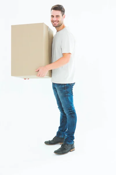 Delivery man carrying cardboard box — Stock Photo, Image