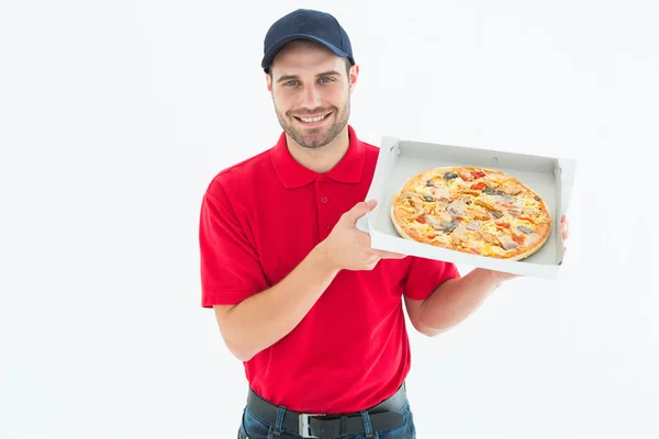 Delivery man showing fresh pizza — Stock Photo, Image