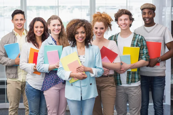 Fashion students smiling at camera together — Stock Photo, Image