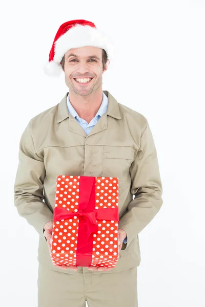 Happy delivery man holding gift — Stock Photo, Image