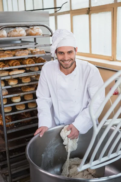 Baker preparing dough in industrial mixer — Stock Photo, Image