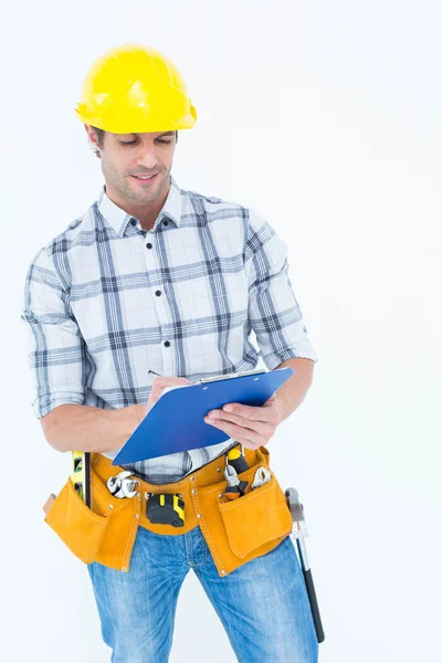 Architect writing notes on clip board — Stock Photo, Image