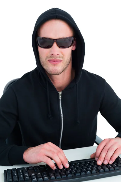 Stern hacker with sunglasses typing on keyboard — Stock Photo, Image