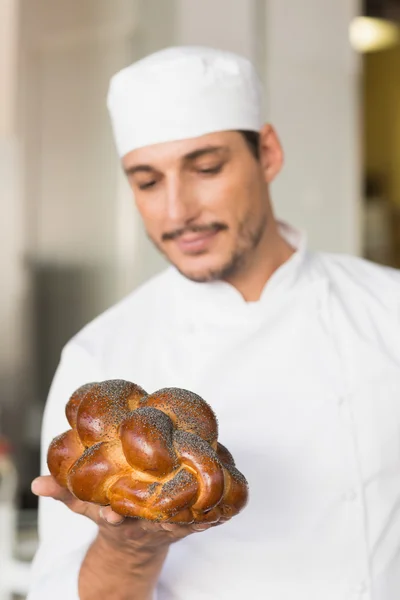 Baker checking freshly baked bread — Stock Photo, Image