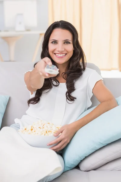 Brunette watching tv on couch — Stock Photo, Image