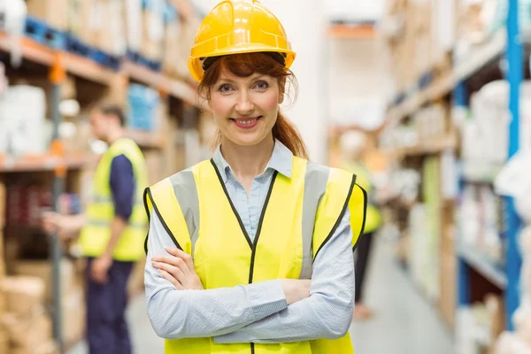 Warehouse manager smiling at camera with arms crossed — Stock Photo, Image