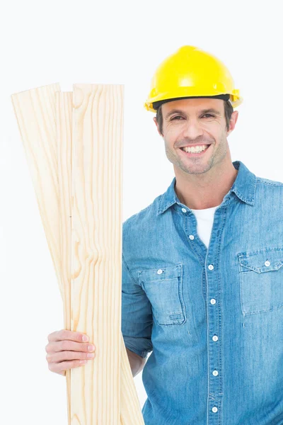 Happy carpenter holding wooden planks — Stock Photo, Image