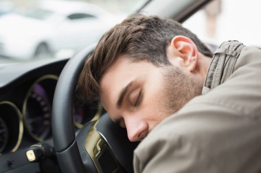Drunk man slumped on steering wheel clipart