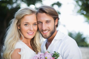 Attractive couple smiling at camera clipart