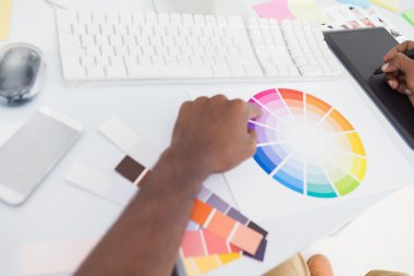 Designer using graphics tablet and colour wheel clipart