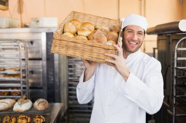 Baker holding basket of bread clipart