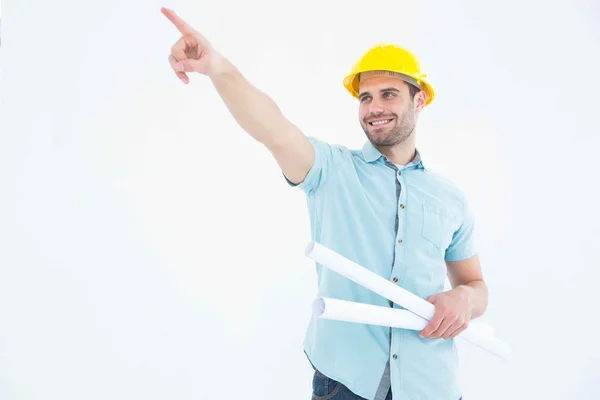 Male architect with blueprints pointing away — Stock Photo, Image