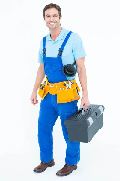 Happy plumber carrying tool box — Stock Photo, Image