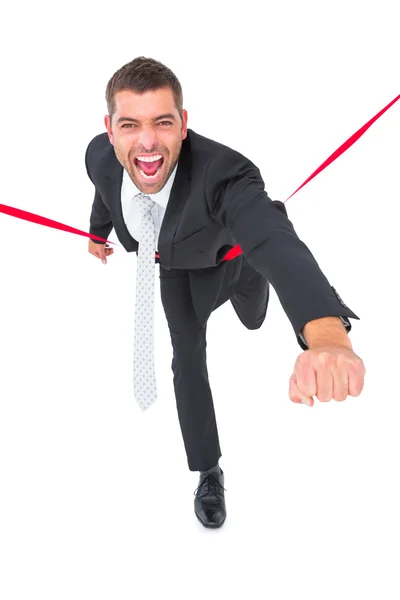 Businessman crossing the finish line — Stock Photo, Image