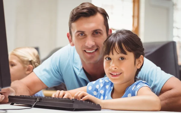 Cute pupil in computer class with teacher — Stock Photo, Image