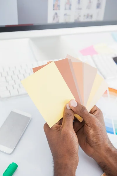 Designer holding colour swatch and choosing — Stock Photo, Image