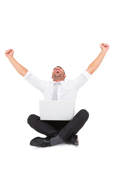 Businessman using laptop and cheering — Stock Photo, Image