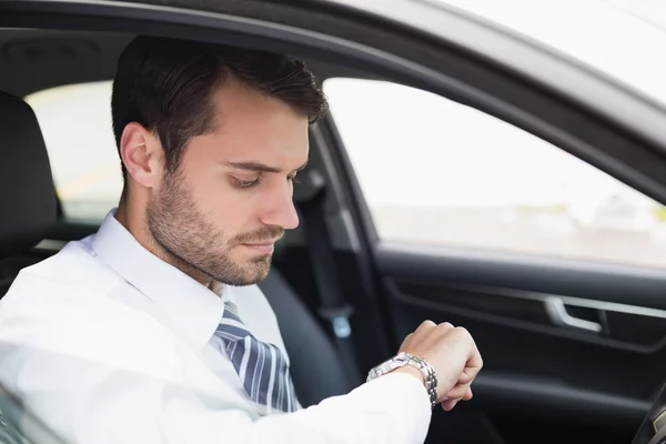 Young businessman in the drivers seat — Stock Photo, Image