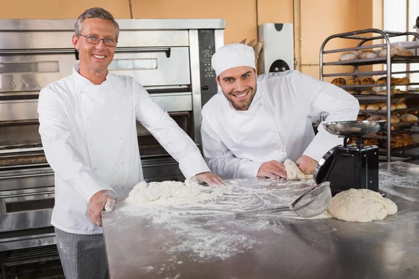Smiling baker kneading dough — Stock Photo, Image