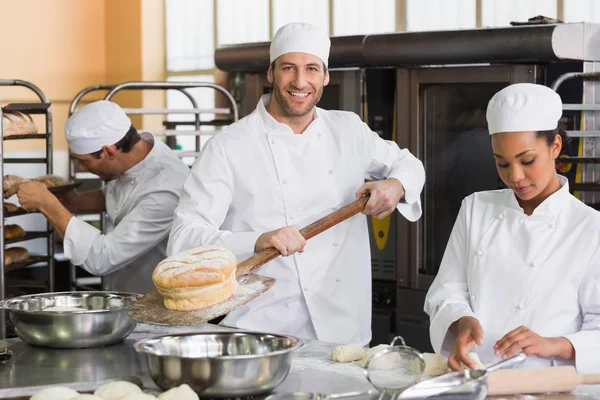 Team of bakers working together — Stock Photo, Image