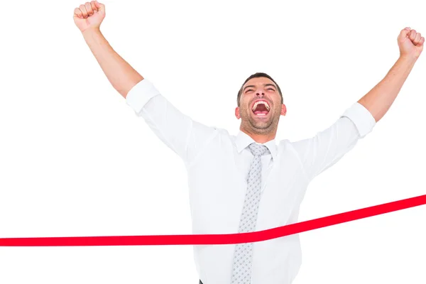 Businessman crossing the finish line — Stock Photo, Image