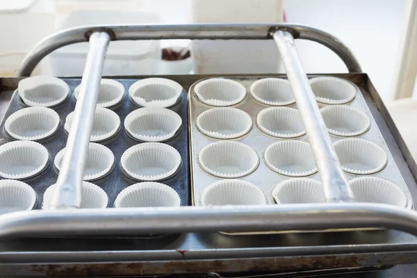 Cupcake holders in trays — Stock Photo, Image